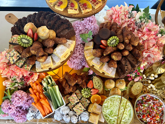 Grazing table with cold cuts, cheeses, fruits, snack items, and other treats